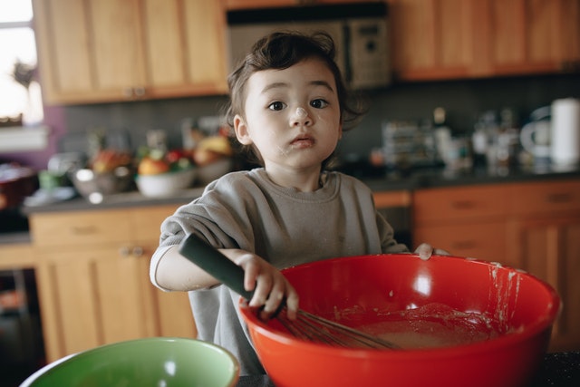 A baby is preparing soup