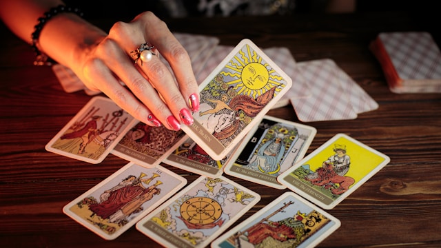 A tarot card in woman hand
